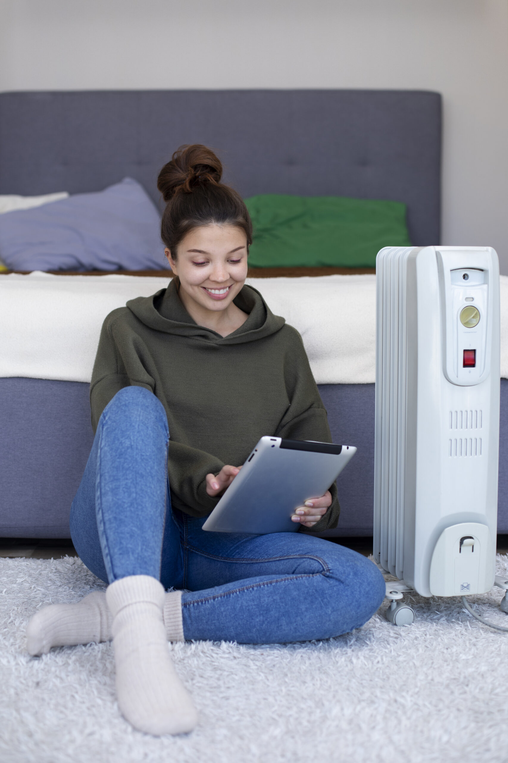 full shot smiley woman holding tablet indoors (1)